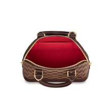Load image into Gallery viewer, Alma BB by Louis Vuitton Available to Rent in Ireland. Interior of the bag is red