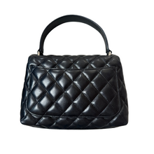 Load image into Gallery viewer, The back of the Chanel Mini Kelly in black lambskin leather with silver hardware
