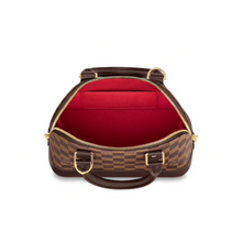 Load image into Gallery viewer, Alma BB by Louis Vuitton Available to Rent in Ireland. Interior of the bag is red
